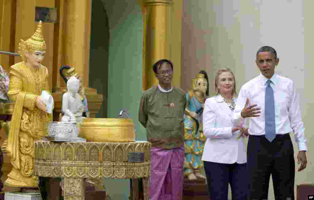 US President Barack Obama speaks to reporters as he tours Shwedagon Pagoda with Secretary of State Hillary Clinton in Rangoon, Burma, Nov 19, 2012.