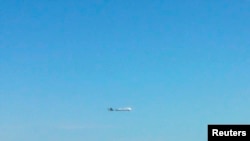 FILE - An unidentified plane flies near disputed islands, called Senkaku in Japan and Diaoyu in China, in the air over the East China Sea, in this handout photo taken by Japan Air Self-Defence Force and released by Joint Staff of the Defence Ministry of J