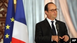French President Francois Hollande gestures during joint news conference with Iraqi counterpart Fouad Massoum, Baghdad, Sept. 12, 2014.
