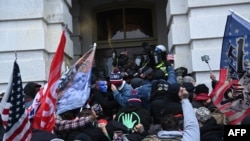 Trump supporters clash with police and security forces as they storm the U.S. Capitol in Washington, Jan. 6, 2021.
