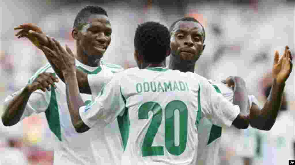 Nigeria's Nnamdi Oduamadi is celebrated after scoring his side's 3rd goal by Sunday Mba, right, and Kenneth Omeruo during the Confederations Cup match between Tahiti and Nigeria.