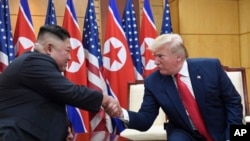 U.S. President Donald Trump and North Korean leader Kim Jong Un meet in the Demilitarized Zone, South Korea, June 30, 2019.