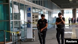 FILE - Police officers patrol at Turkey's largest airport, Istanbul Ataturk, June 29, 2016. Two men were detained after a police pursuit at the airport Saturday.
