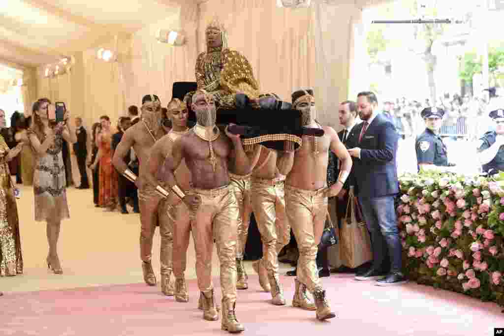 Billy Porter is carried on the red carpet as he arrives at the Metropolitan Museum of Art's Costume Institute benefit gala in New York, May 6, 2019.