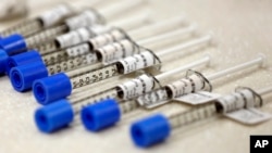 FILE - Syringes filled with the opioid painkiller fentanyl are shown in an inpatient pharmacy, June 1, 2018. A new report from the Kentucky Office of Drug Control Policy says 1,565 people died in the state from drug overdoses in 2017, an 11.5 percent incr