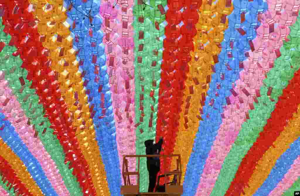 A worker attaches a name tag of a Buddhist who made a donation to a lantern for the upcoming celebration of Buddha's birthday on May 12 at the Jogye temple in Seoul, South Korea.