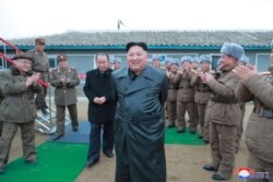 FILE -North Korean leader Kim Jong Un oversees a super-large multiple launch rocket system test in this undated picture released by North Korea's Central News Agency (KCNA) on Nov. 28, 2019.