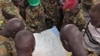Soldiers from the Sudan People's Liberation Army (SPLA) examine a map at the front line position in Pana Kuach, Unity State, South Sudan, May 11 2012.
