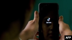 FILE - A mobile phone user opens the Chinese-owned video-sharing 'Tik Tok' app on a device in Bangalore, India, June 30, 2020.