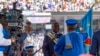 A Constitutional Court judge hands the national flag to President Felix Tshisekedi after taking the oath of office, on the day of his ceremony at the Stade des Martyrs in Kinshasa, on January 20, 2024.