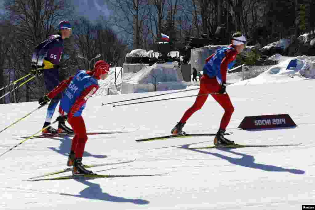 Swiss team members ski past an anti-aircraft missile battery during a training session for the 2014 Sochi Winter Olympic Games in Rosa Khutor, Feb. 6, 2014.