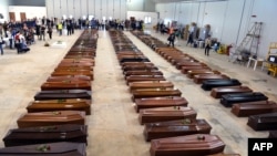 Cercueils des victimes du naufrage de Lampedusa dans un hangar de l'aéroport de l'île italienne le 5 octobre 2013.