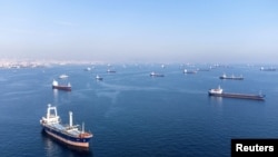 FILE PHOTO: Commercial vessels including vessels which are part of Black Sea grain deal wait to pass the Bosphorus strait off the shores of Yenikapi in Istanbul