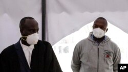 FILE -Kenyan police officer Duncan Ndiema Ndiwah, right, appears to face murder charges at the High Court June 23, 2020.