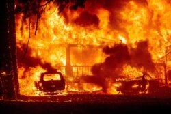 Flames consume a home on Highway 89 as the Dixie Fire tears through the Greenville community of Plumas County, Calif., on Aug. 4, 2021.