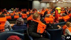 FILE - This photo provided by Michal Stewart shows passengers on board the Viking Sky, waiting to be evacuated, off the coast of Norway, March 23, 2019.