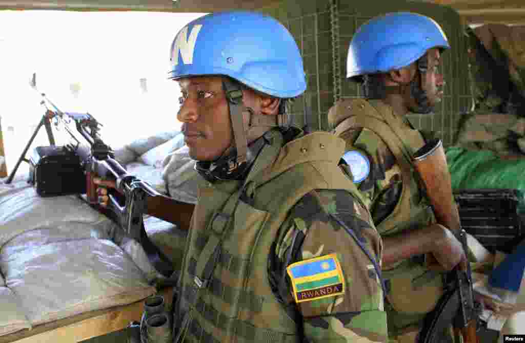 Soldiers from Rwanda serving under United Nations Mission in South Sudan keep watch from an observatory point at Tomping camp, near Juba, Jan. 7, 2014.