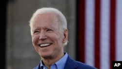 FILE- Joe Biden, the presumptive Democratic nominee for president in the 2020 election, acknowledges the crowd during a campaign rally in Kansas City, March 7, 2020