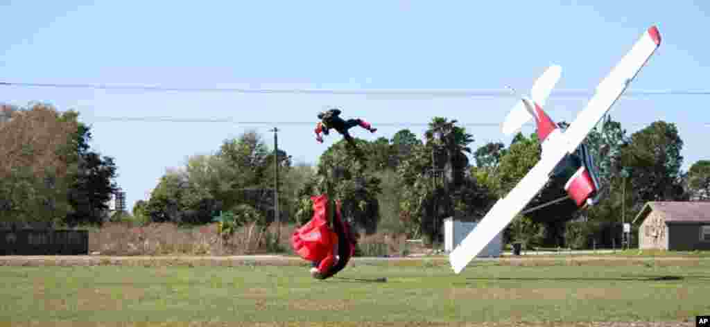This photo released by the Polk County Sheriff's Office shows a plane nose-diving into the ground after getting tangled with a parachutist, at the South Lakeland Airport in Mulberry, Florida, Both the pilot and jumper were hospitalized with minor injuries, March 8, 2014.