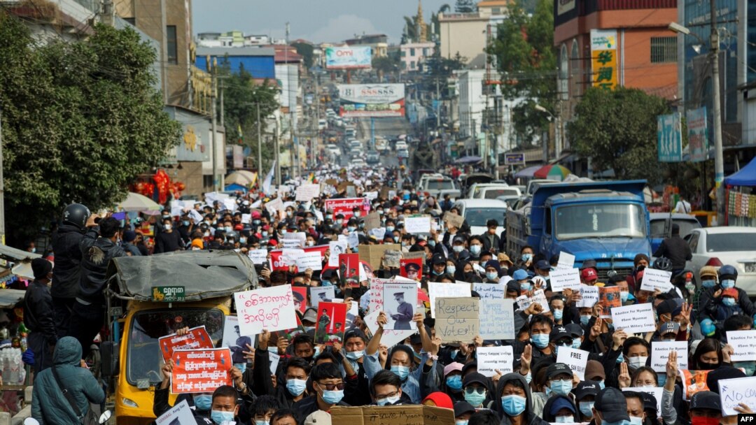 People take part in a demonstration against the February 1 military coup, along a street in the town of Muse in Shan state, near the China-Myanmar border on February 8, 2021. (Photo by STR / AFP)