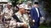 Murad Ebrahim, chairman of the Moro National Liberation Front, walks with his security group before the start of anews conference inside their camp at Sultan Kudarat in Maguindanao province, southern Philippines, September 5, 2011. 