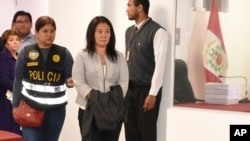  Keiko Fujimori enters the chief prosecutor's office, with a jacket covering her handcuffs, in Lima, Peru, Oct. 10, 2018, in this photo provide by Peru's Justice Department.