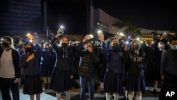 Protesters wave their smartphones as they sing "Glory to Hong Kong" during a rally for secondary school students near the Hong Kong Museum of Art in Hong Kong, Dec. 13, 2019. 