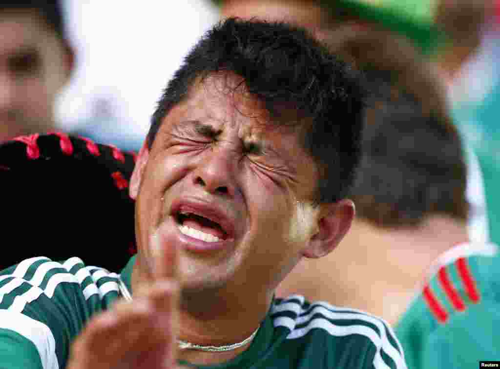 A Mexico fan reacts after his team lost to the Netherlands at the Castelao arena in Fortaleza, June 29, 2014.