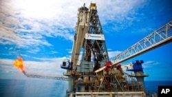 Discoverer Enterprise on the site of the Deepwater Horizon incident. Gas from the damaged Deepwater Horizon wellhead is burned by the drillship Discoverer Enterprise, in a process known as flaring. Gas and oil from the wellhead are being brought to the su