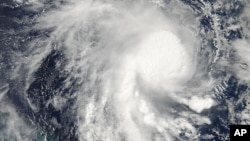 This image from NASA's Aqua satellite and made available by NASA's Goddard MODIS Rapid Response Team shows Cyclone Marcia in the Coral Sea, off the northeast coast of Australia, Feb. 18, 2015.