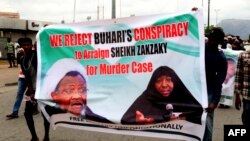 FILE - Supporters march with a banner to press for the release of Nigerian Shiite Muslim cleric Ibrahim Zakzaky on May 14, 2018 in Abuja. 