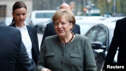 FILE - Angela Merkel, leader of the Christian Democratic Union (CDU), arrives at the German Parliamentary Society offices before the start of exploratory talks about forming a new coalition government in Berlin, Germany, Nov. 10, 2017. 