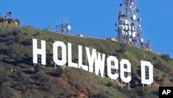 The Hollywood sign in Los Angeles, California, is seen altered Jan. 1, 2017. Los Angeles residents awoke New Year's Day to find a prankster had changed the landmark sign to read "HOLLYWEED."