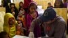 FILE - A Pakistani paramedic takes a blood sample from a girl for a HIV test at a state-run hospital in Rato Dero in the district of Larkana of the southern Sindh province, May 9, 2019. 
