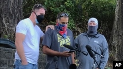 Luke Carrillo, center, speaks about Aaron Danielson at a news conference on Aug. 31, 2020, in Portland, Ore. Danielson, a supporter of the right-wing Patriot Prayer group, was killed on Aug. 29.