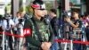 An armed Thai military police stands guard at the entrance to a hall of the Thai Army Club prior to a meeting between Thai Armed Forces Chiefs and high ranking officials in Bangkok, Thailand, May 20, 2014.