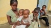 File - A 34-year-old displaced single mother, is seen with her five children in Nebelet, Tigray region, Ethiopia, as food aid runs out there, July 21, 2021. 