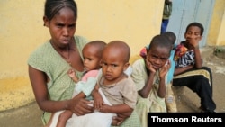 File - A 34-year-old displaced single mother, is seen with her five children in Nebelet, Tigray region, Ethiopia, as food aid runs out there, July 21, 2021.