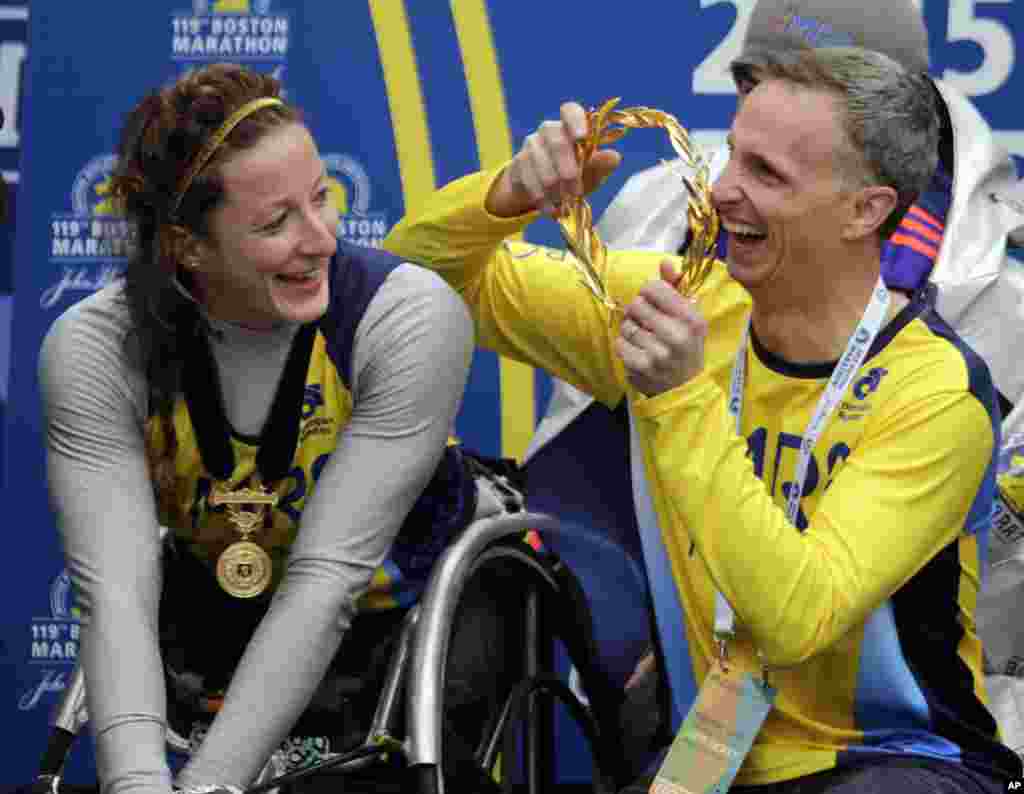 Bill Richard, father of 2013 Boston Marathon bombing victim Martin Richard, prepares to put the victor's wreath on women's wheelchair division winner Tatyana McFadden of Russia, at the Boston Marathon, April 20, 2015.