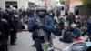 FILE - Riot police detain protesters after clashes broke out with activists on the sidelines of the traditional May Day rally in the center of Paris, France, May 1, 2018. 