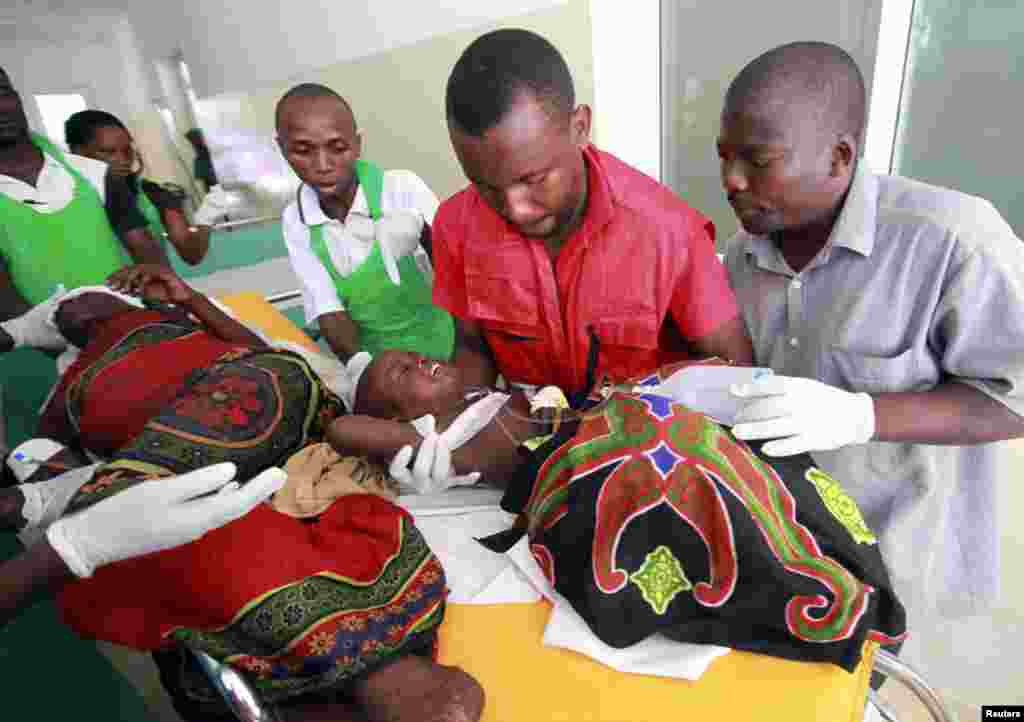 Paramedics at the Malindi district hospital attend to a child injured when their community members were attacked at Tana River district in Kenya's coastal Tana Delta region December 21 2012.