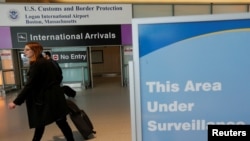 FILE - International travelers arrive at Logan International Airport in Boston following a federal court's temporary stay of U.S. President Donald Trump's executive order travel ban, Feb. 6, 2017. 
