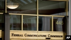 FILE - The entrance to the Federal Communications Commission (FCC) building is seen in Washington, June 19, 2015.