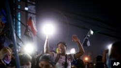 People gather at Plaza Italia on the day Chileans voted in a referendum to decide whether the country should replace its 40-year-old constitution, written during the dictatorship of Gen. Augusto Pinochet, in Santiago, Oct. 25, 2020.