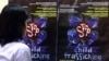 FILE - A Filipino girl looks at posters condemning child trafficking inside a shelter for runaway child laborers in Manila.