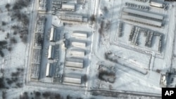 This handout satellite image released by Maxar Technologies shows a close up of armored personnel carriers and trucks at Russia's Klimovo storage facility, in Bryansk Oblast, 13 kilometers north of the Russia/Ukraine border, Jan. 19, 2022.