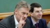 Russian President Vladimir Putin's spokesman Dmitry Peskov, left, speaks during a meeting in Moscow, Russia, Dec. 9, 2012. 