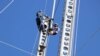 Workers for the country's electricity supplier installing damages electricity poles in Chikwawa district. (Lameck Masina/VOA)