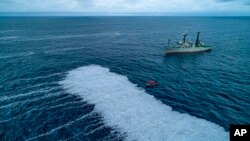 In this photo provided by Sea Shepherd on Feb.5, 2022, activists approach a spill of dead fish in the Bay of Biscay, off La Rochelle, western France on Feb.3, 2022.