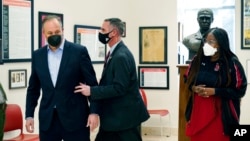 Doug Emhoff, the husband of Vice President Kamala Harris, is whisked out of an event at a high school by a Secret Service agent following an apparent security concern, in Washington, Feb. 8, 2022.
